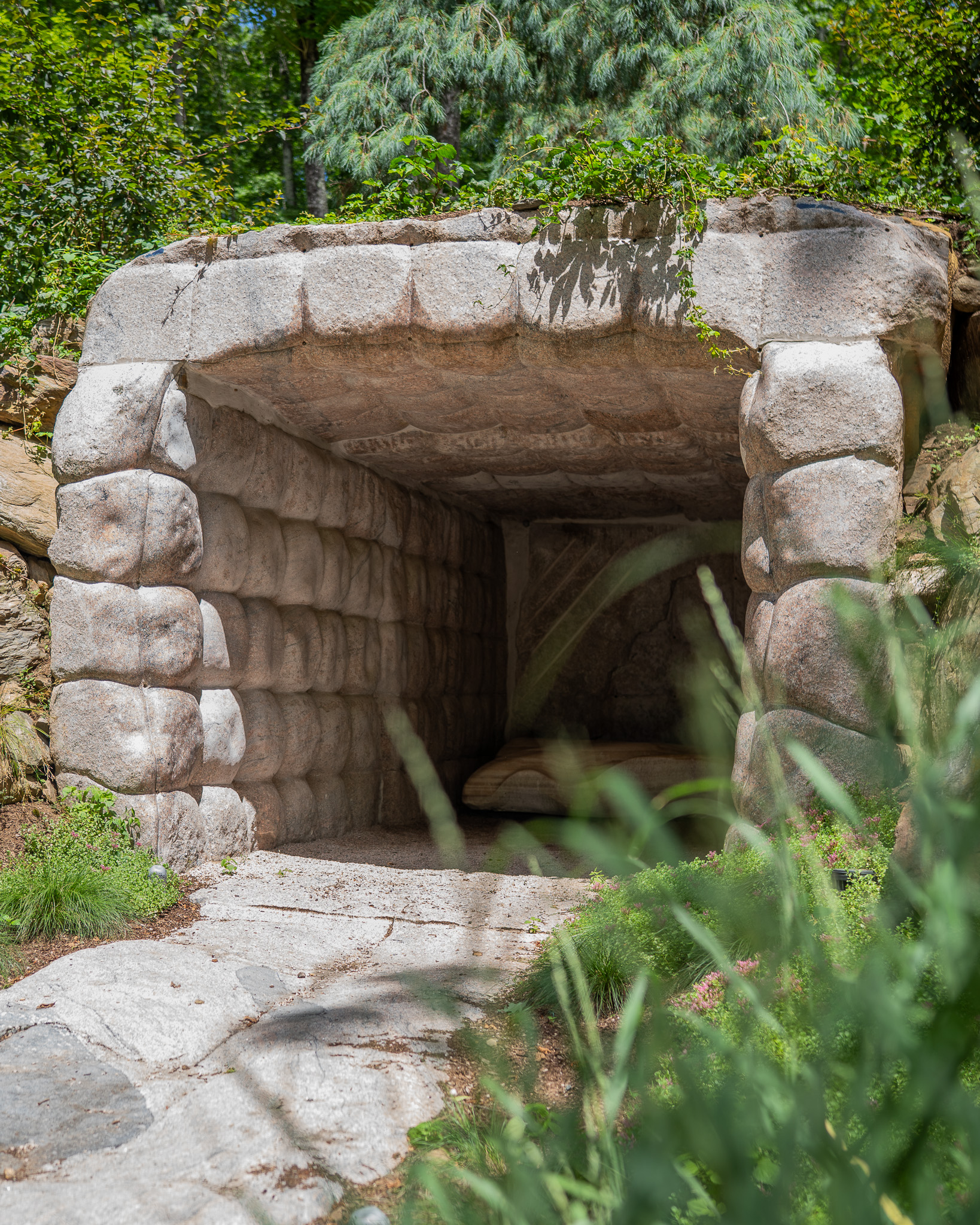Closer view of the cave opening showing hand-carved granite